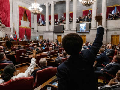 Democratic state Reps. Justin Jones (lower left) of Nashville and Justin Pearson (center) of Memphis gesture to supporters during the vote in which they were expelled from the state Legislature on April 6, 2023, in Nashville, Tennessee.