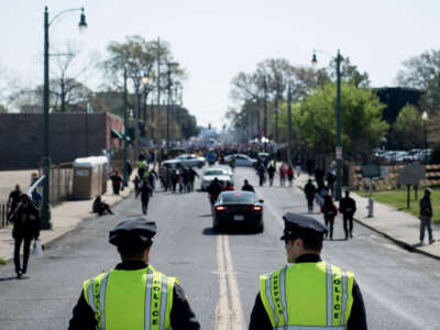 Police watch while people gather for a labor march on the 50th anniversary of the assassination of Martin Luther King Jr. on April 4, 2018, in Memphis, Tennessee.