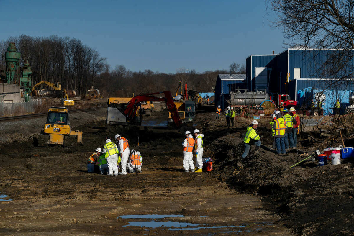 Workers clean up the toxic spill left in the aftermath of the East Palestine Train Disaster