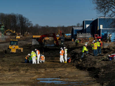 Workers clean up the toxic spill left in the aftermath of the East Palestine Train Disaster