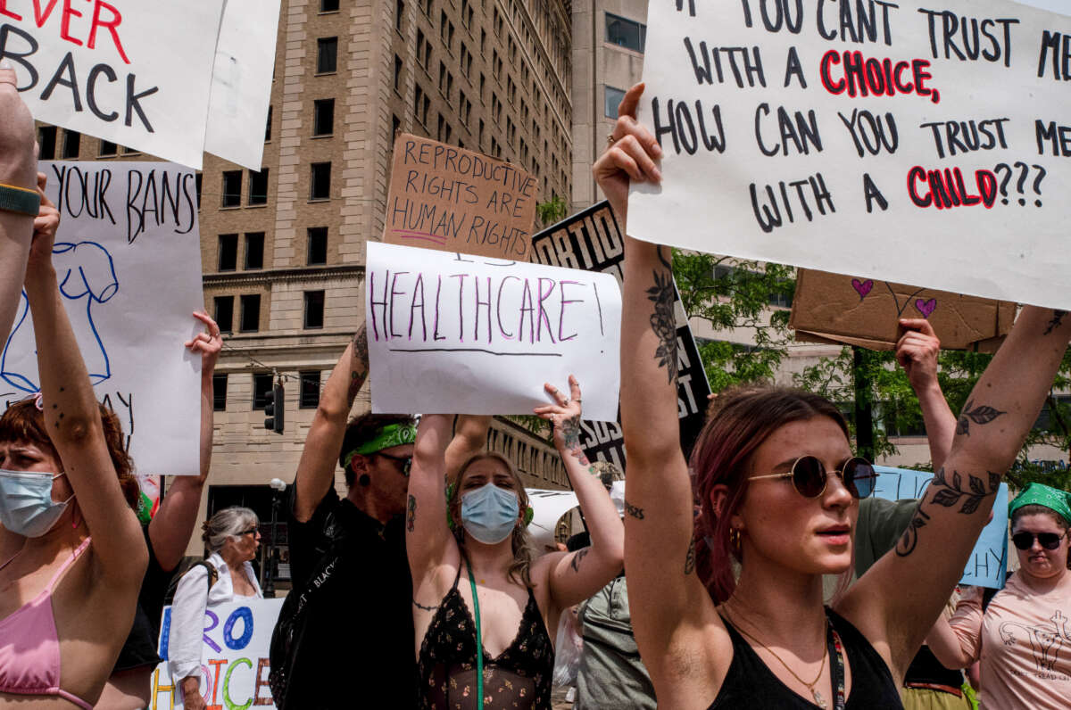 Protesters hold signs at a rally in support of abortion rights in Dayton, Ohio, on May 14, 2022.