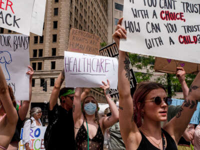 Protesters hold signs at a rally in support of abortion rights in Dayton, Ohio, on May 14, 2022.