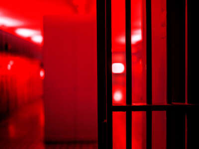 Prison bars in red light