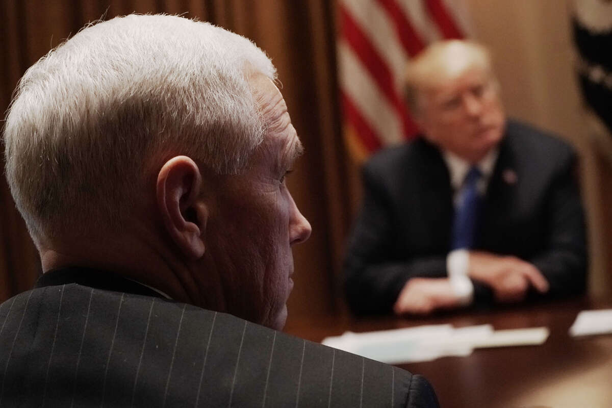 President Donald Trump (right) and Vice President Mike Pence (left) listen during a meeting with bipartisan members of the Congress at the Cabinet Room of the White House February 28, 2018, in Washington, D.C.