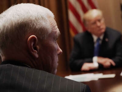 President Donald Trump (right) and Vice President Mike Pence (left) listen during a meeting with bipartisan members of the Congress at the Cabinet Room of the White House February 28, 2018, in Washington, D.C.