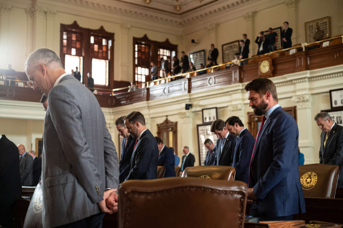 Texas state representatives bow their heads in prayer in the House chamber during an invocation at the start of the 87th Legislature's special session at the State Capitol on July 8, 2021, in Austin, Texas.