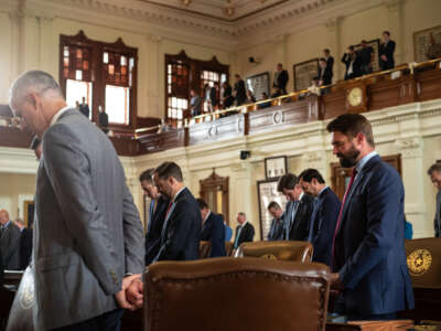 Texas state representatives bow their heads in prayer in the House chamber during an invocation at the start of the 87th Legislature's special session at the State Capitol on July 8, 2021, in Austin, Texas.