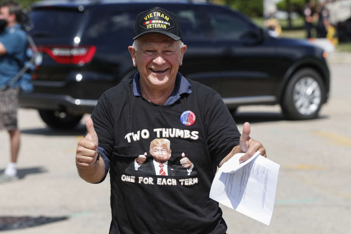 A Donald Trump supporter with a Vietnam Veteran cap arrives to attend a rally in Oshkosh, Wisconsin, on August 17, 2020.