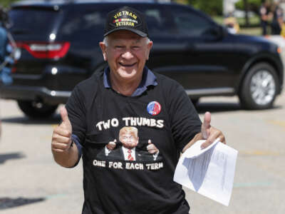 A Donald Trump supporter with a Vietnam Veteran cap arrives to attend a rally in Oshkosh, Wisconsin, on August 17, 2020.