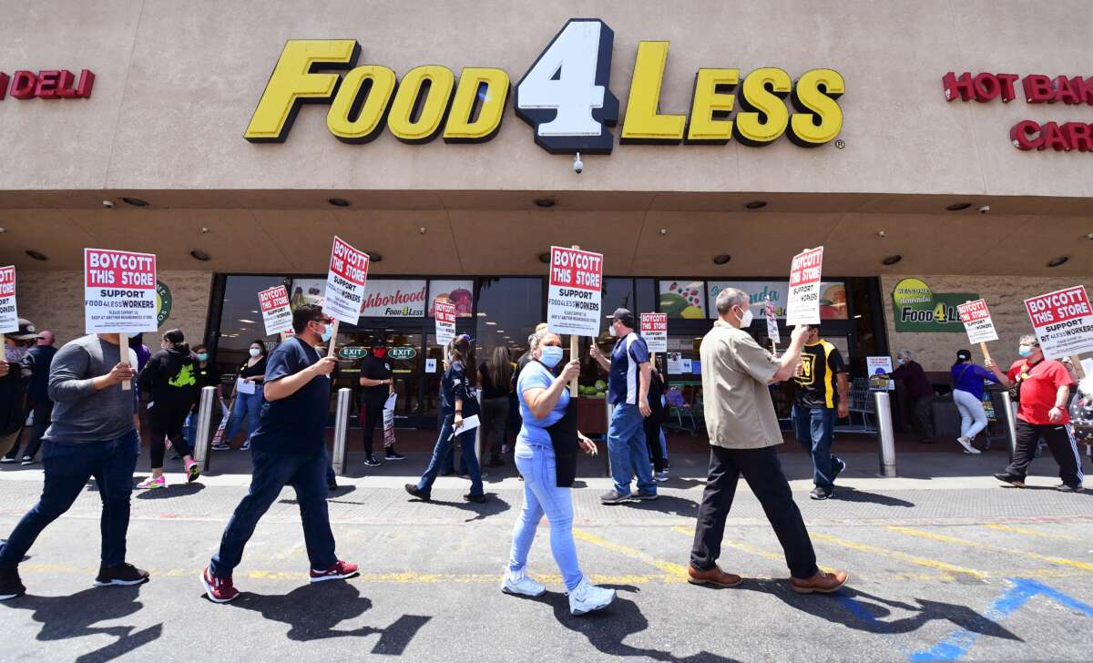 Grocery store workers represented by the United Food and Commercial Workers International Union (UFCW) hold a boycott rally in front of a Food4Less Supermarket in Los Angeles, California on May 12, 2021.