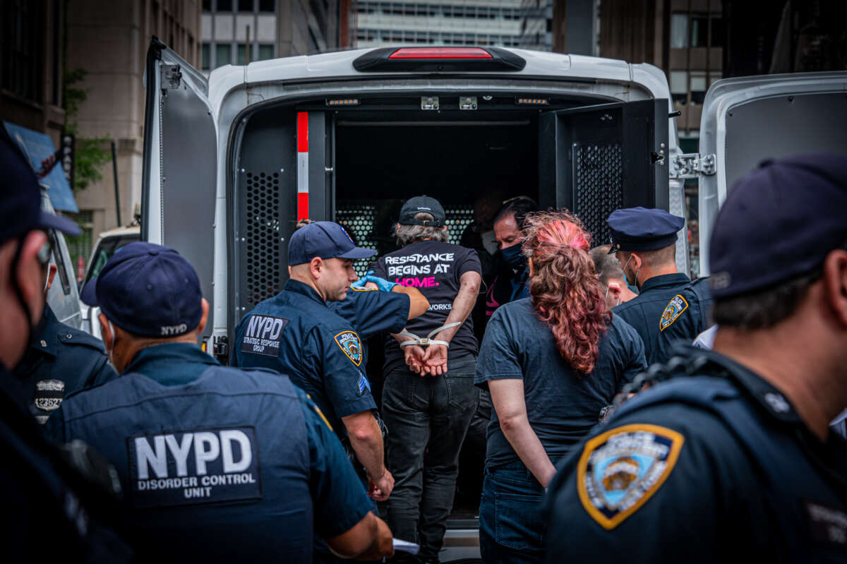 A protester seen getting arrested for blocking the street during a direct action outside New York City Hall to call out Mayor Bill de Blasio's record on homelessness on July 20, 2021, in New York City.