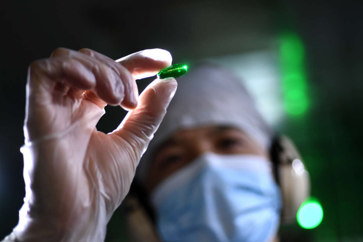 An employee works at Humanwell PuraCap Pharmaceuticals, a major Chinese softgel pharmaceutical manufacturer, in China's Hubei province, October 25, 2021.