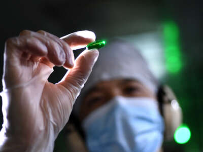 An employee works at Humanwell PuraCap Pharmaceuticals, a major Chinese softgel pharmaceutical manufacturer, in China's Hubei province, October 25, 2021.