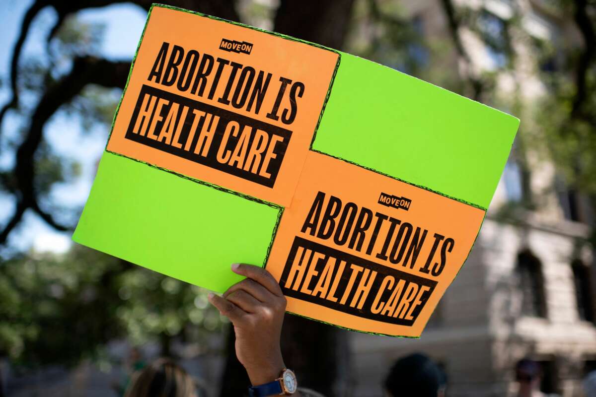 An abortion rights demonstrator holds a sign outside the Harris County Courthouse during the Women's Wave nationwide march in Houston, Texas, on October 8, 2022.