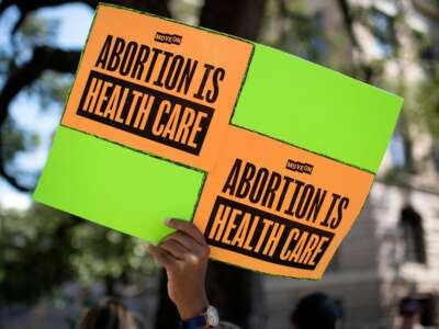 An abortion rights demonstrator holds a sign outside the Harris County Courthouse during the Women's Wave nationwide march in Houston, Texas, on October 8, 2022.