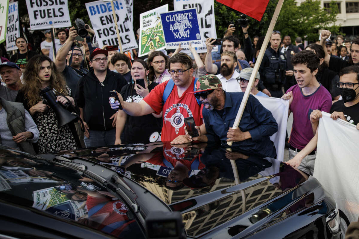 Climate demonstrators block a government vehicle from getting through the entrance to the White House Correspondents' Dinner at the Washington Hilton on April 29, 2023 in Washington, D.C.