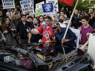 Climate demonstrators block a government vehicle from getting through the entrance to the White House Correspondents' Dinner at the Washington Hilton on April 29, 2023 in Washington, D.C.