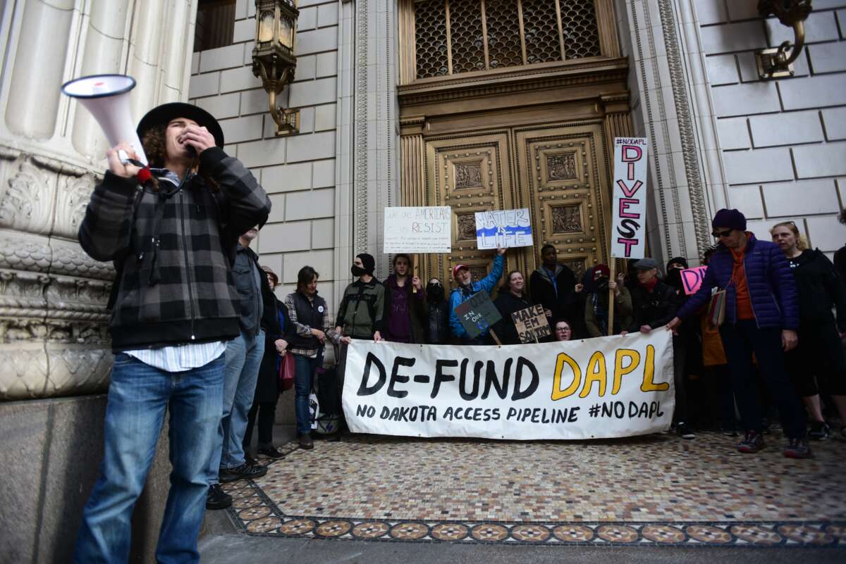 Protesters rally outside a bank to speak out against investment in the Dakota Access Pipeline in Portland, Oregon, on February 17, 2017.