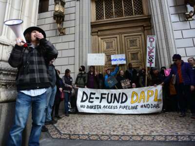 Protesters rally outside a bank to speak out against investment in the Dakota Access Pipeline in Portland, Oregon, on February 17, 2017.