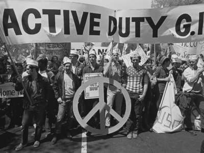 A group of active duty American soldiers out of uniform from the group 'GIs for Peace' carry a large banner and march amid others during a protest against the war in Vietnam, Washington, D.C., April 24, 1971.