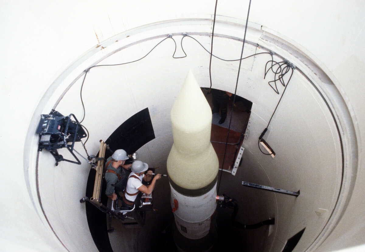 Two missile maintenance crewmen perform an electrical check on an LGM-30F Minuteman II intercontinental ballistic missile (ICBM) in its silo at Whiteman Air Force Base, Missouri.
