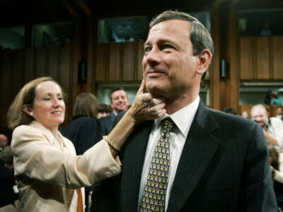 Jane Sullivan Roberts (L), wife of Supreme Court Chief Justice Nominee John Roberts (R), wipes lipstick from Roberts's cheek after giving him a kiss at the end of the judge's testimony during confirmation hearings before the Senate Judiciary Committee September 15, 2005 in Washington, D.C.