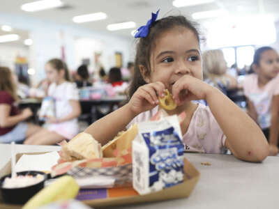 Valerie Yanez, 4 eats a smiley face fry during her lunch period in the cafeteria at Doby Elementary School in Apollo Beach, Florida on October 4, 2019.