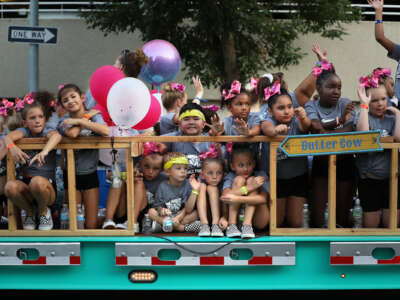 Children ride on a trailer as they roll along Grand Avenue during in the Iowa State Fair Parade August 07, 2019 in Des Moines, Iowa.