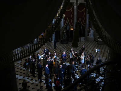 Kevin McCarthy speaks to reporters in a darkened government hall