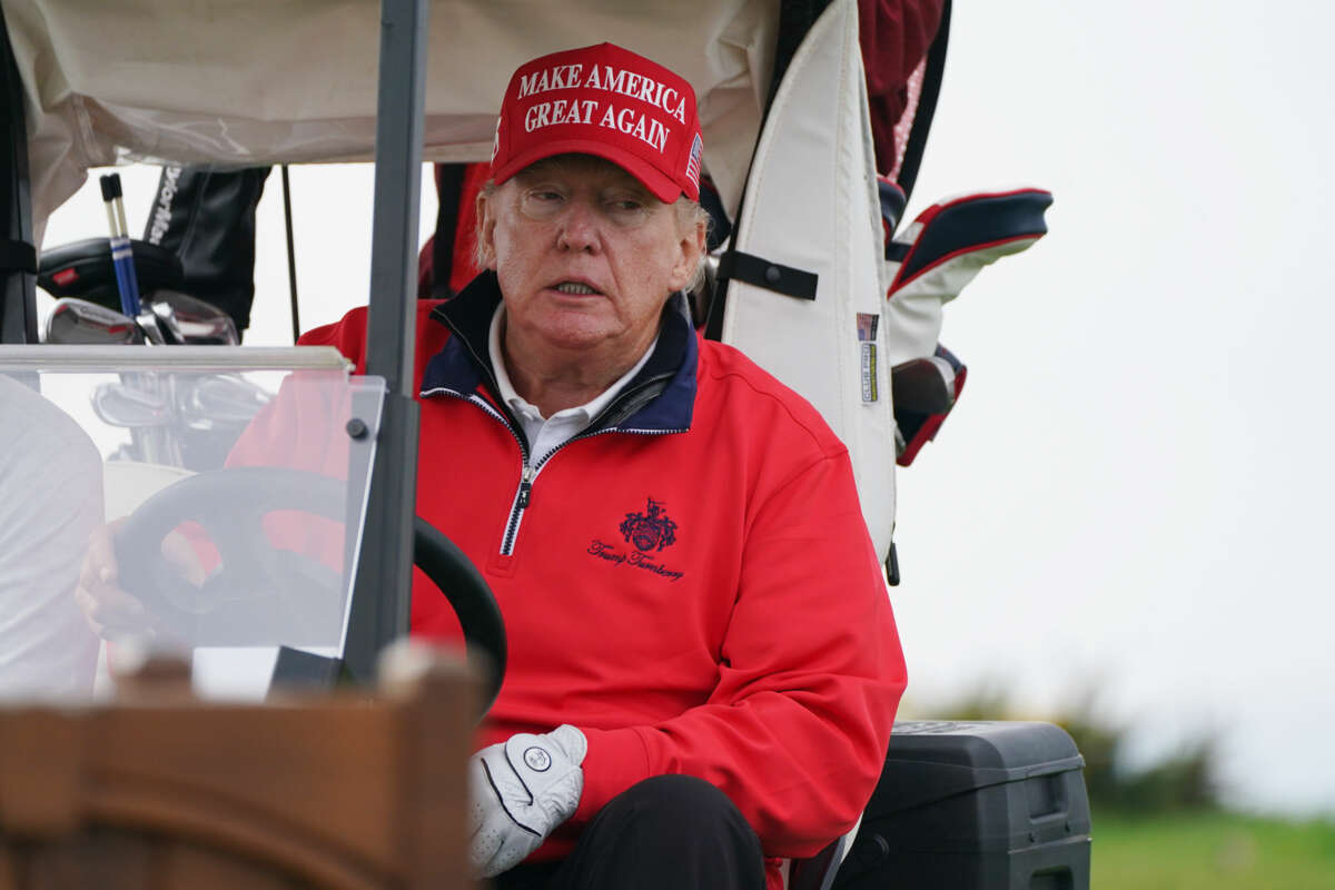 Donald Trump sits in a golf cart