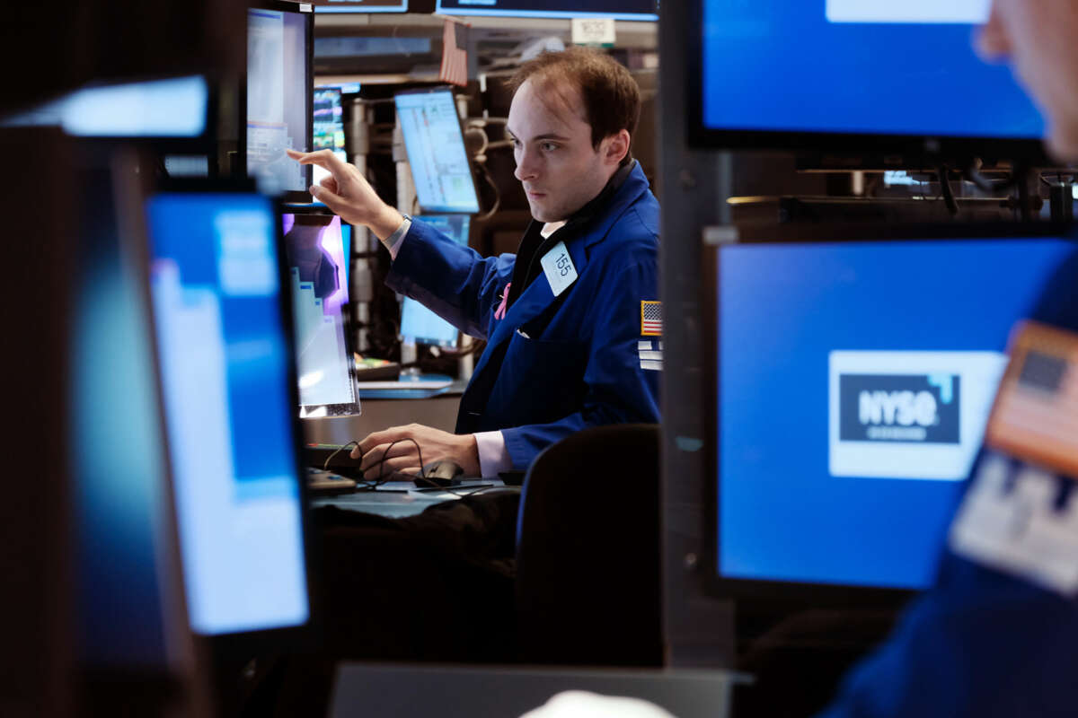 A man looks at computer screens inside of the New York Stock Exchange