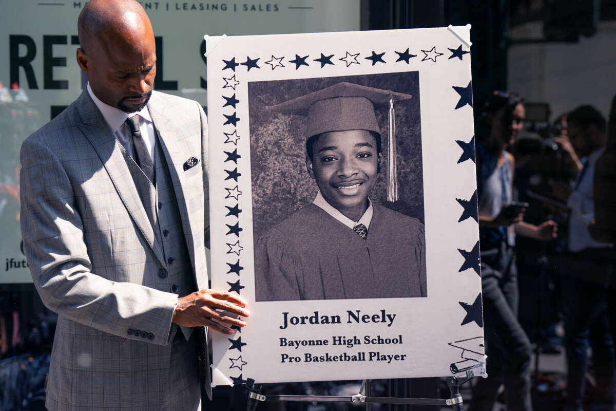 Andre Zachary, father of deceased Jordan Neely, adjusts a memorial portrait for a press conference in the wake of the arrest of Daniel Penny in New York City, on May 12, 2023.