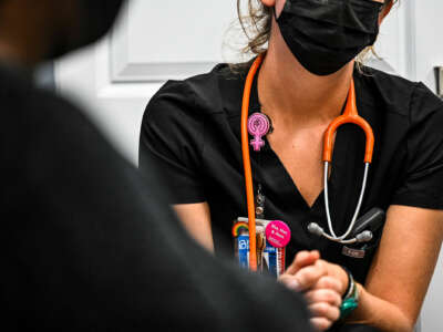 A clinic worker speaks with a patient