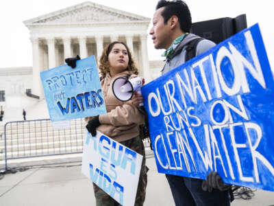 Jaime Sigaran, right, of American Rivers, and his sister Bethsaida, attend a rally to call for protection of the Clean Water Act outside of the U.S. Supreme Court as it begins a new term on October 3, 2022 as the court hears arguments in the case of Sackett v. Environmental Protection Agency.