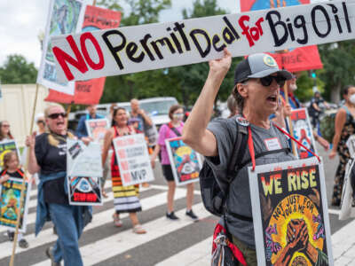 Demonstrators with Appalachian and Indigenous climate advocates march against the Mountain Valley Pipeline project approved as part of the Inflation Reduction Act in Washington, D.C., on September 8, 2022, with signs that read "No Permit Deal for Big Oil"