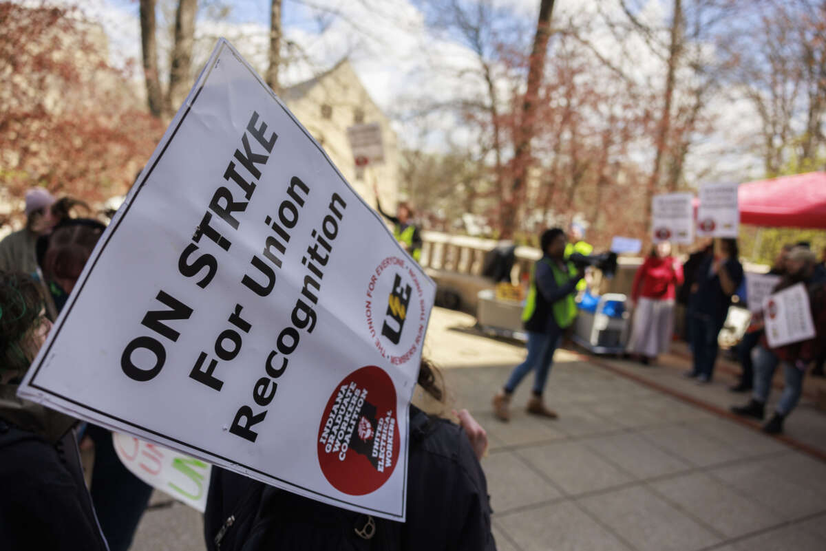 Members of the Indiana Graduate Workers Coalition and their supporters picket outside the chemistry building while striking for union recognition in Bloomington, Indiana, on April 19, 2022.