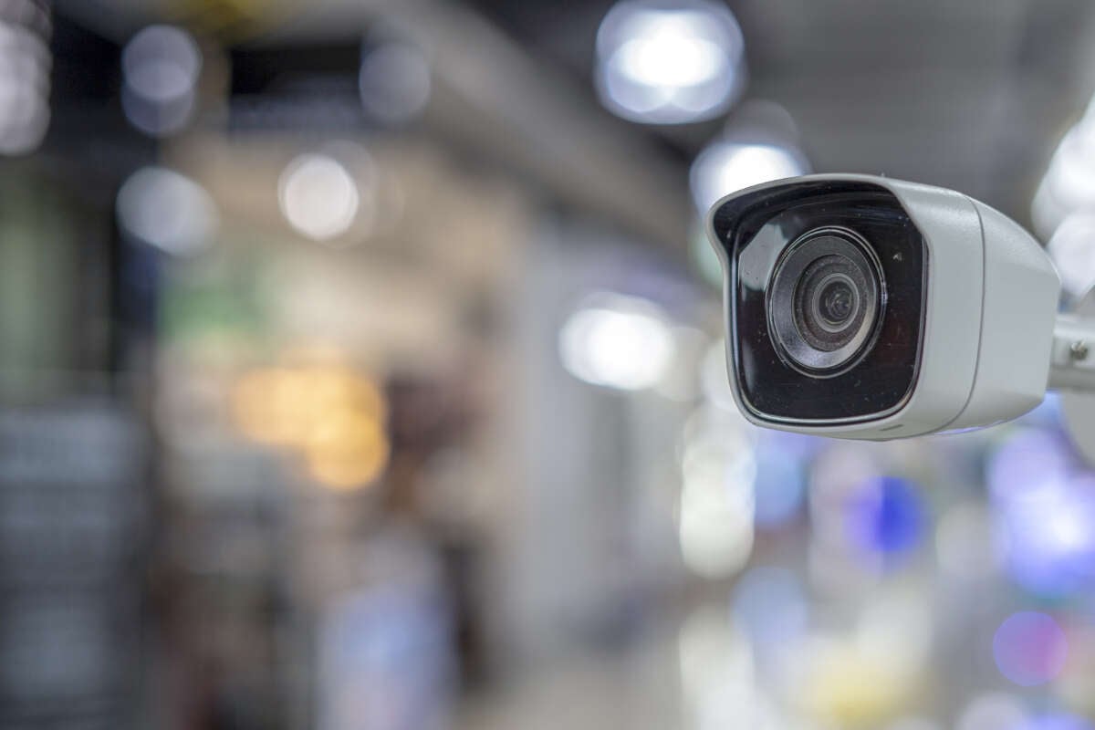 White security camera against a blurry background