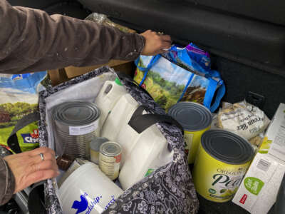 A woman loads her car with food during a food giveaway event at the Richford Congregational Church in Richford, NY on December 5, 2019.