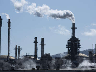 A refinery spews out greenhouse gases, one of the main causes of global warming, in the refining process of oil.
