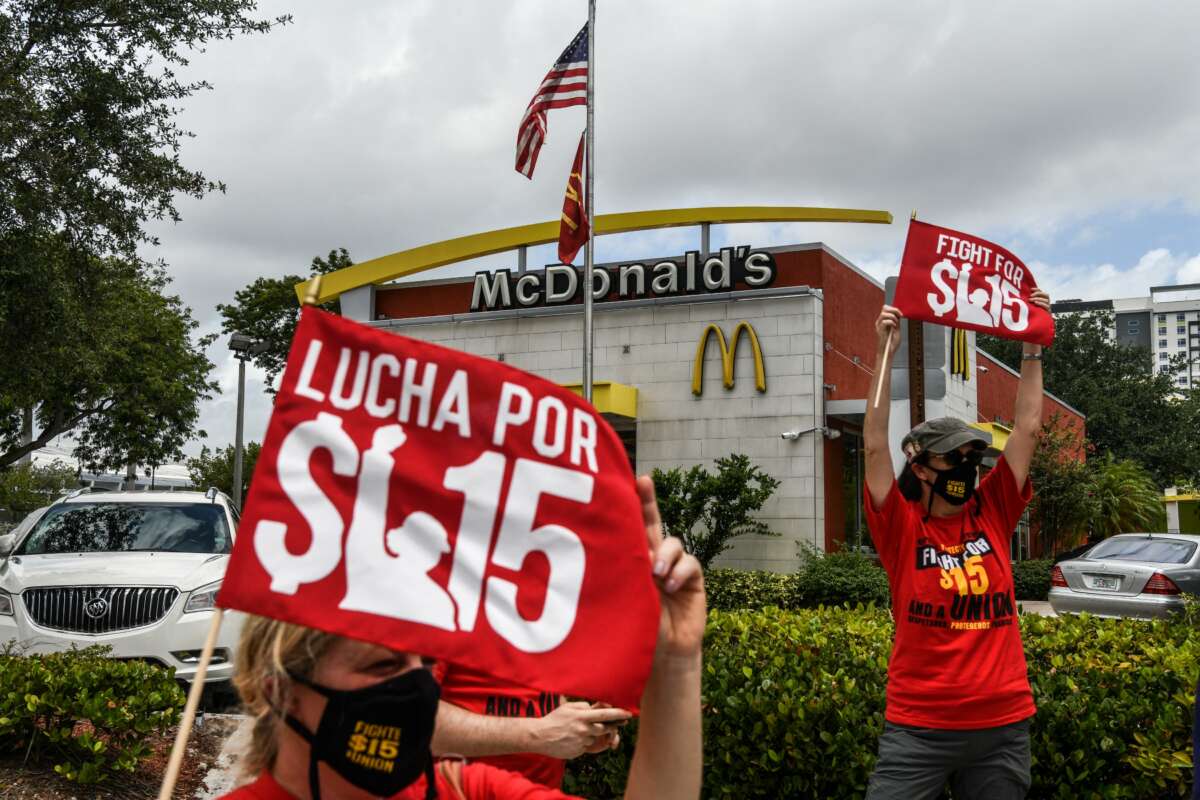 Employees of McDonald's protest outside a branch calling for a raise in their minimum wage to $15 an hour, in Fort Lauderdale, Florida, on May 19, 2021.