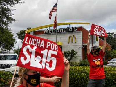 Employees of McDonald's protest outside a branch calling for a raise in their minimum wage to $15 an hour, in Fort Lauderdale, Florida, on May 19, 2021.