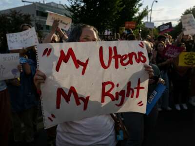 A pro-choice demonstrator holds a sign reading "My Uterus My Right" as activists protest outside the Planned Parenthood Reproductive Health Services Center after the overturning of Roe v. Wade by the Supreme Court, in St. Louis, Missouri on June 24, 2022.