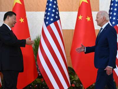 U.S. President Joe Biden (right) and China's President Xi Jinping (left) shake hands as they meet on the sidelines of the G20 Summit in Nusa Dua, Bali, Indonesia, on November 14, 2022.