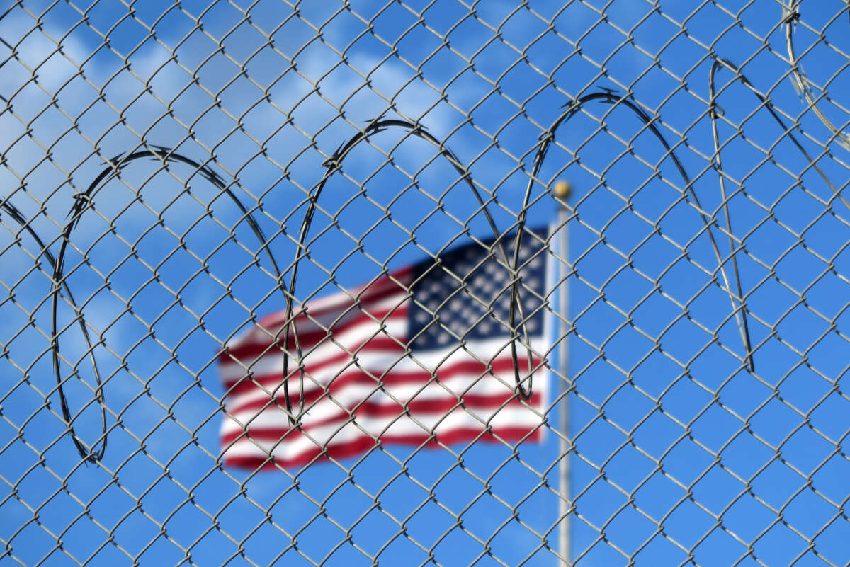 A U.S. flag flies behind barbed wire at the notorious U.S. prison camp on the Guantánamo Bay Naval Base in Cuba, on January 15, 2023.
