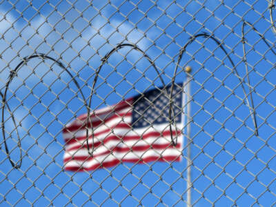 A U.S. flag flies behind barbed wire at the notorious U.S. prison camp on the Guantánamo Bay Naval Base in Cuba, on January 15, 2023.