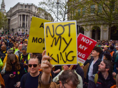 A protester holds a 'Not my king' placard at a demonstration in Trafalgar Square during the coronation of King Charles III, in London, U.K., on May 6, 2023.