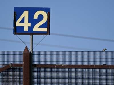 The number 42 is displayed above a gate on the border wall along the US-Mexico border in El Paso, Texas