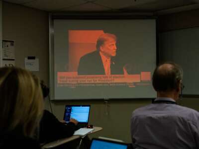 Reporters watch a CNN town hall with former president and 2024 presidential hopeful Donald Trump at St. Anselm College in Manchester, New Hampshire, on May 10, 2023.