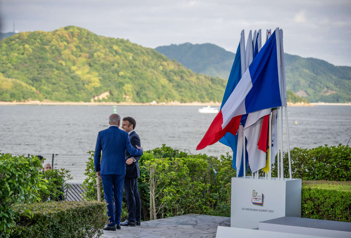 U.S. President Joe Biden speaks with Emmanuel Macron, president of France, on the second day at the G7 summit.
