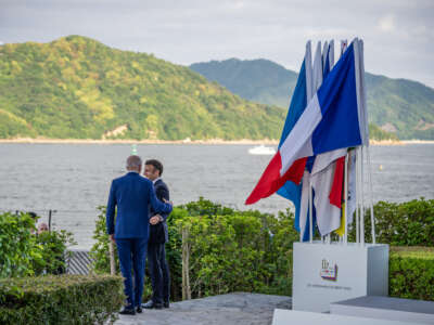 U.S. President Joe Biden speaks with Emmanuel Macron, president of France, on the second day at the G7 summit.